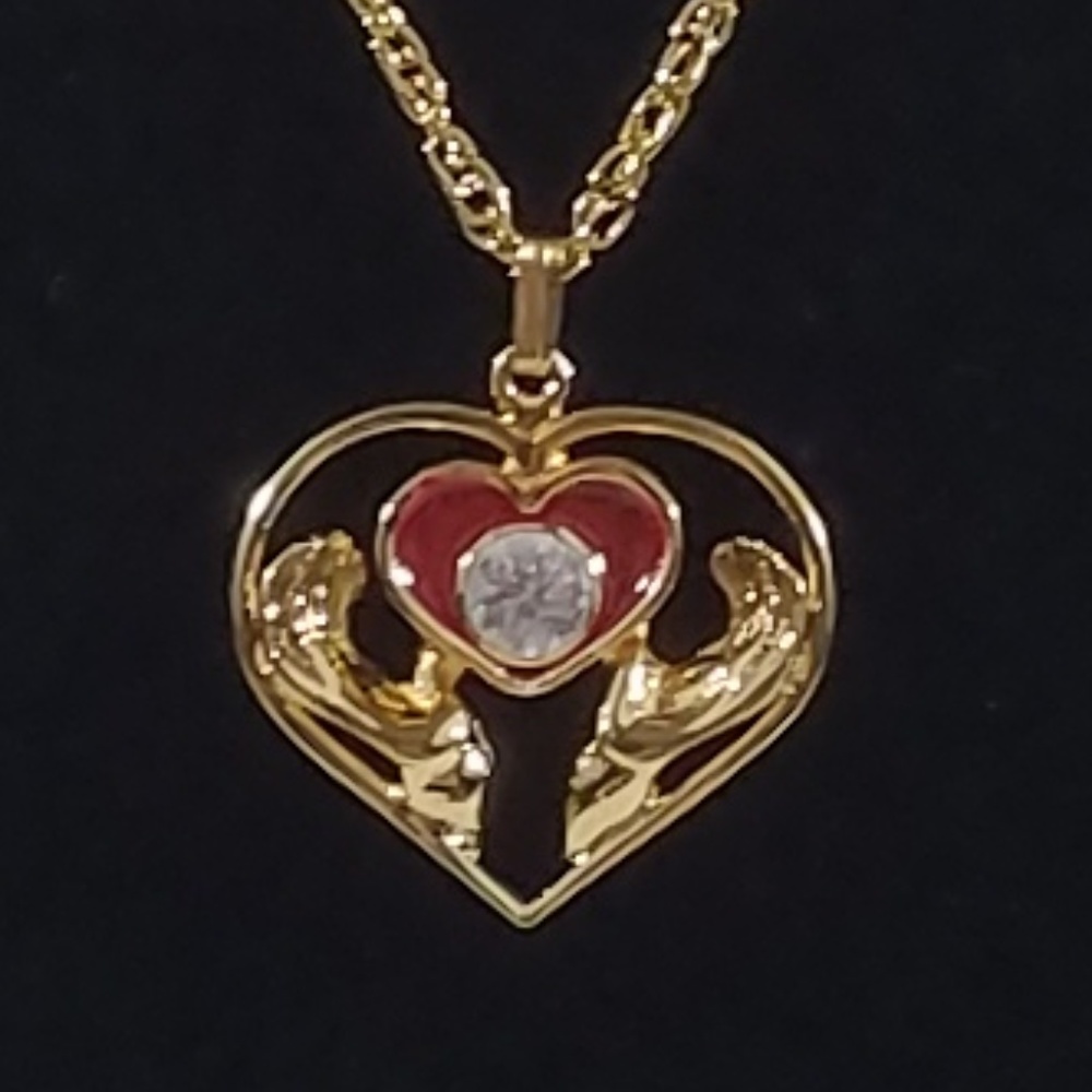 Hands Holding Red Heart Necklace
